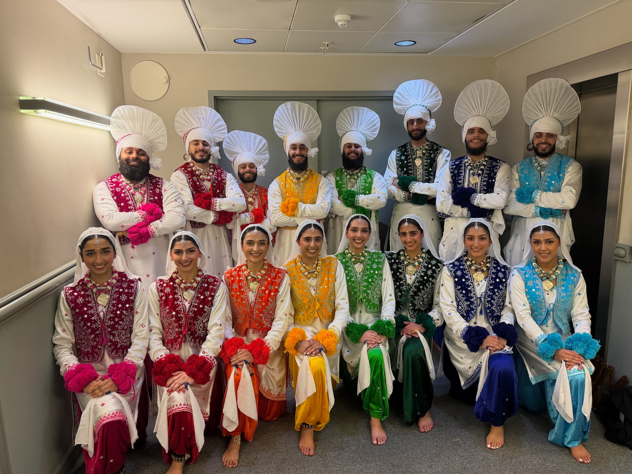 The LU Bhangra troupe in colourful traditional costumes before a performance