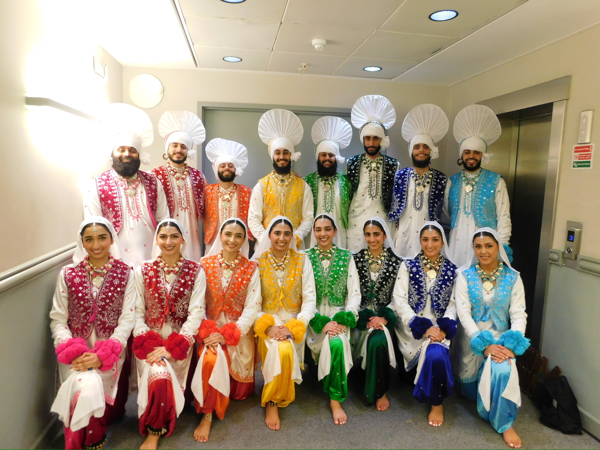 The LU Bhangra troupe together in colourful performance costumes