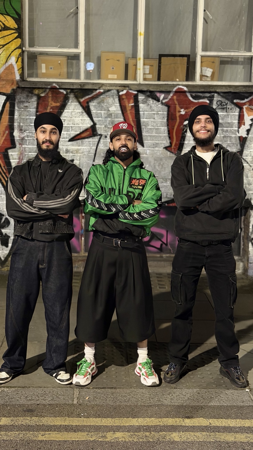 Raf-Saperra standing with two LU Bhangra team members